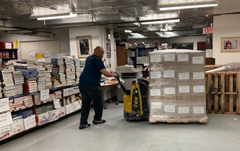 Left: Contractors from JK Movers shrink wrapping a pallet of books in the Book Project’s packing room; Right: a contractor from Canon loading a pallet of shrink wrapped book for transporting from the packing room to the Landover warehouse